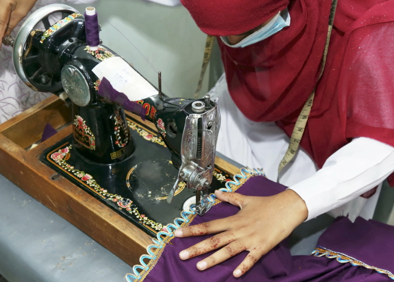 Woman in Pakistan using a sewing machine