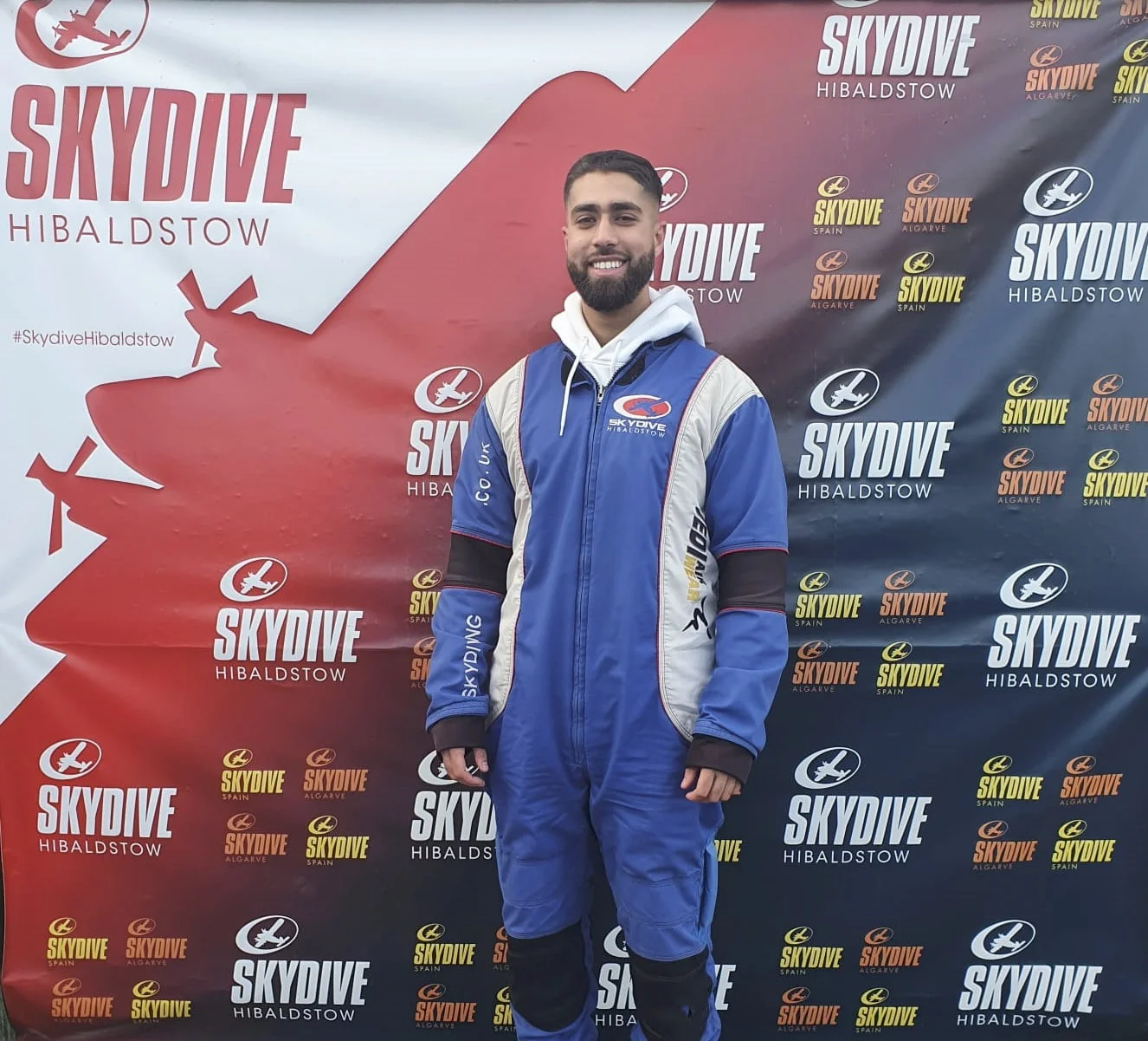 A man in a skydiving suit supporting the get involved movement for As-Salaam Humanitarian Foundation