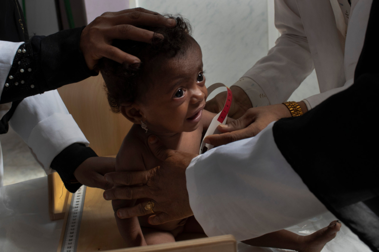 Baby having her health checked at a charity healthcare clinic