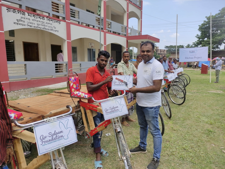 A man handing over keys to a Rikshaw as a part of a charity project to help the poor.