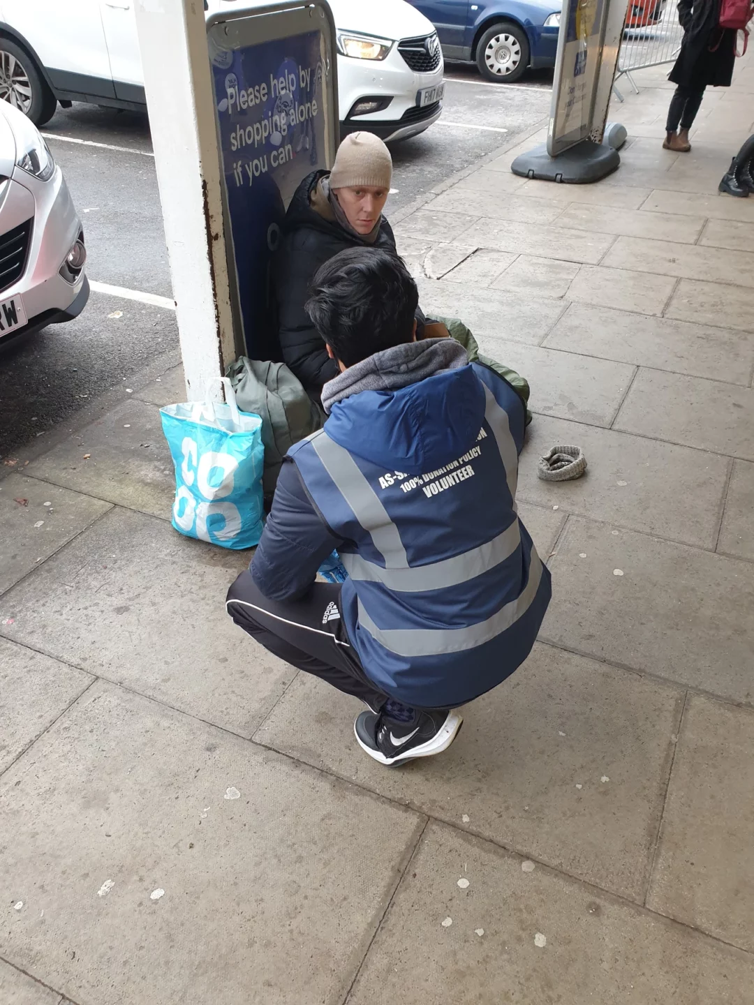 An As-Salaam Humanitarian Foundation Volunteer helping a homeless man in the UK.