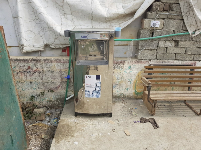 A water filter, cooler and dispenser installed as part of As-Salaam's clean water project