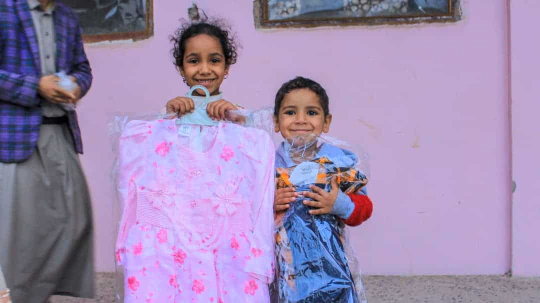 Young Children in Yemen holding their eid gifts