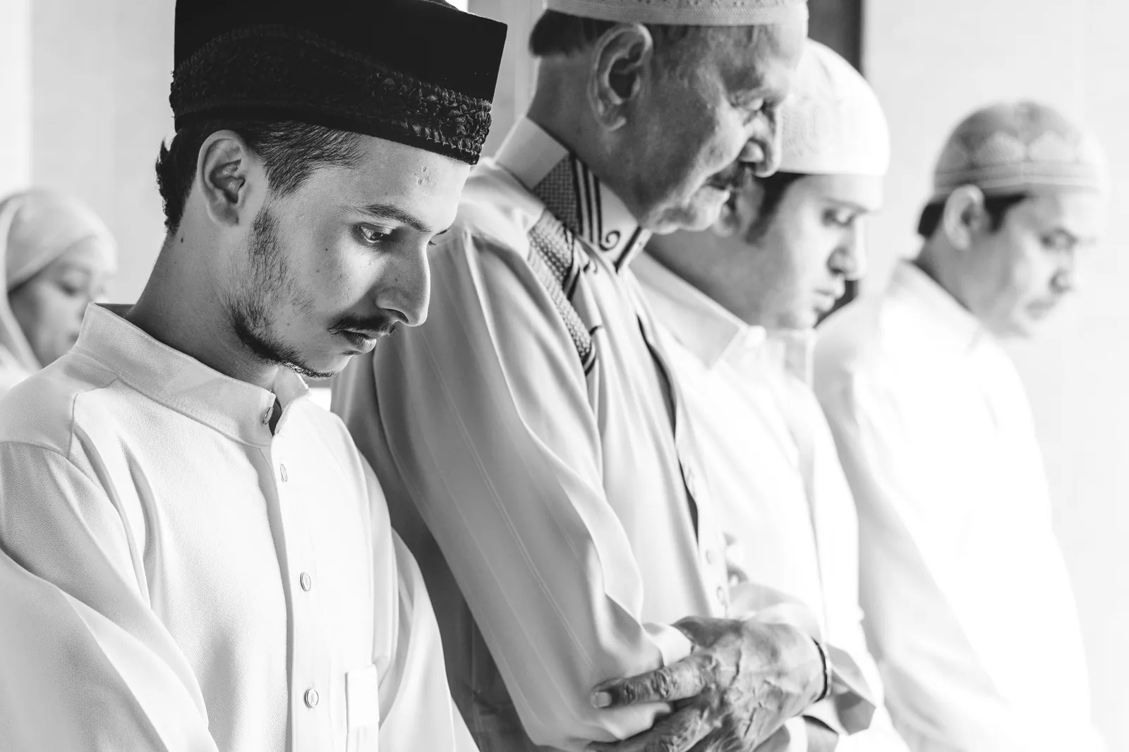 How to Pray the Janazah Prayer 1 Muslim men standing side by side in prayer with their hands folded